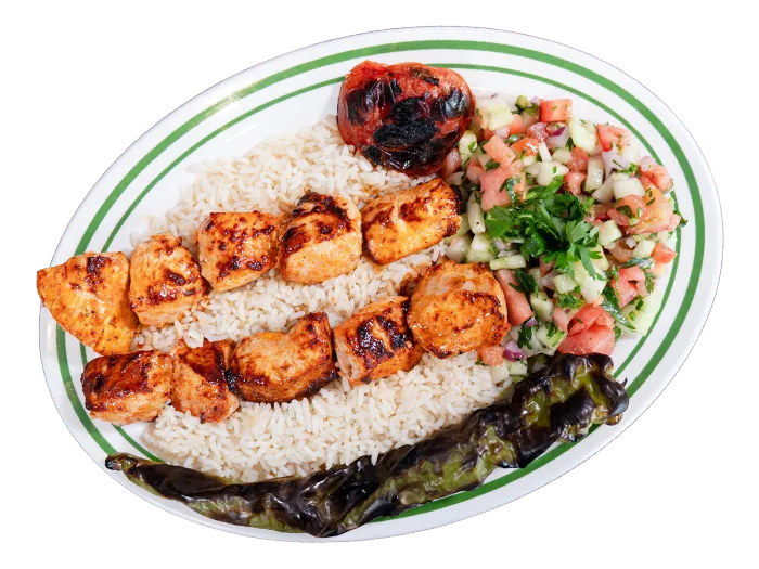 Chicken kebab on skewer, golden-charred, over rice